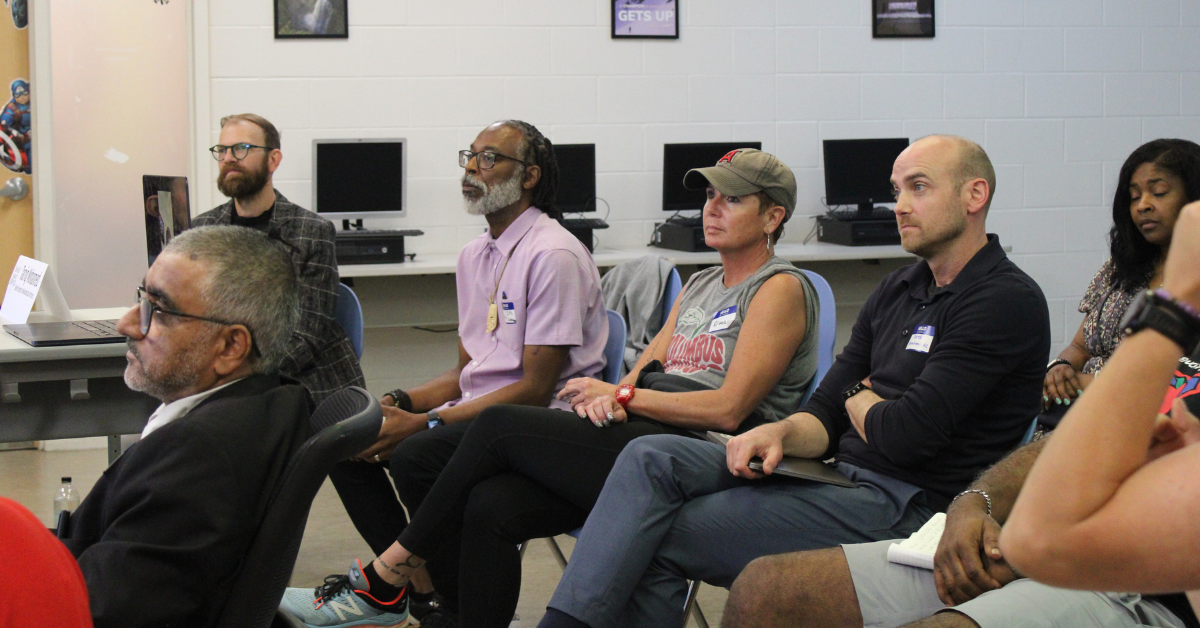 staff members sitting in chairs